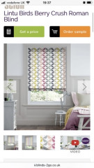 Colourful blind in neutral kitchen