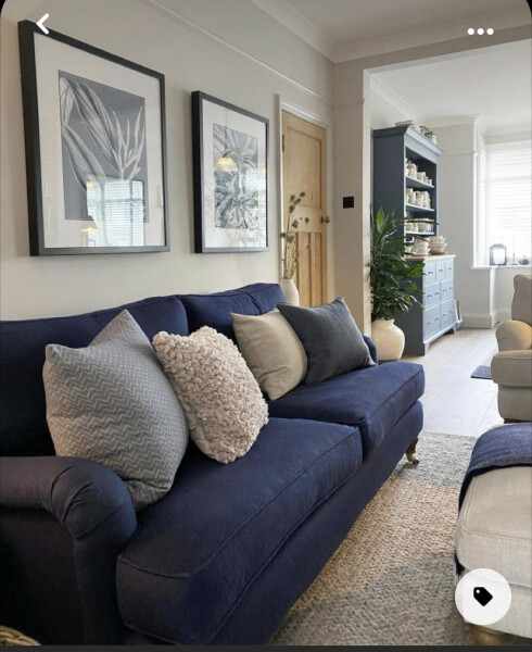 Navy sofa, light sage walls