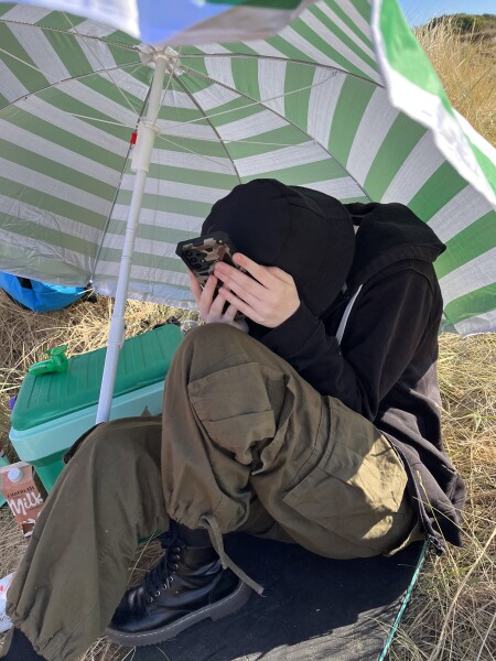 My DS aged 14 is on the beach in a sweatshirt and a jacket. 