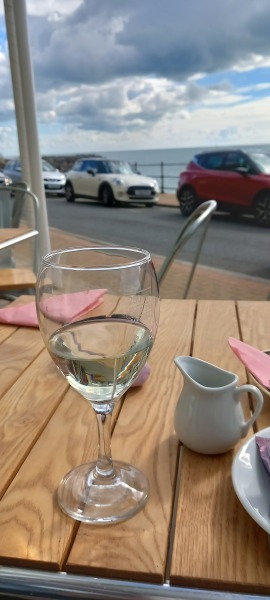 Drinking wine at lunch time on my own on a uk beach
