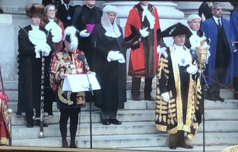 What official wears all black robes and a purple sash? (Photo incld)