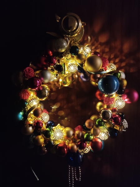 What do you do with the battery holder on a lighted wreath??