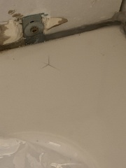 Plumber damaged bath while fitting it