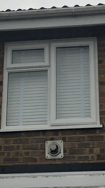 What is this exterior vent below window? 
