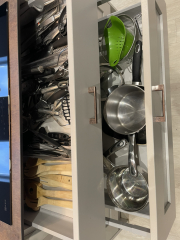 Storing utensils in pan drawers.