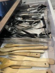 Storing utensils in pan drawers.