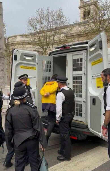Arrested for holding a banner - can't ruin a big day, can we...