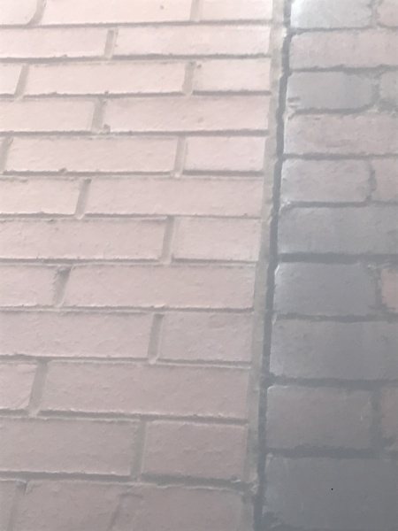 Vertical crack going down brick wall 