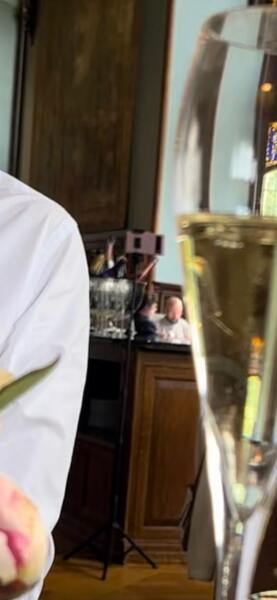 Being filmed by another diner in a fancy restaurant