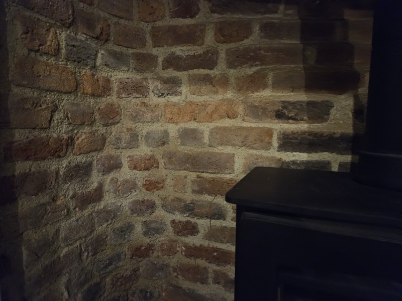 What to do with these ugly bricks in fireplace?