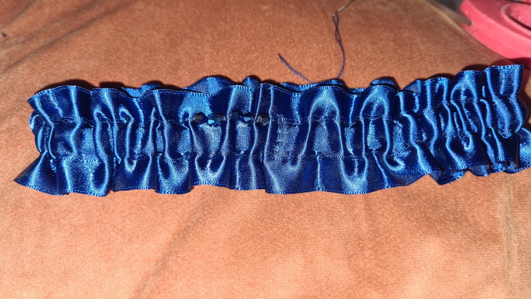 Oh my word, there must be an easier way to hand sew beads onto a garter?