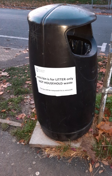 Putting rubbish in a public bin
