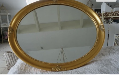 Gold framed mirror for pale blue room in old house