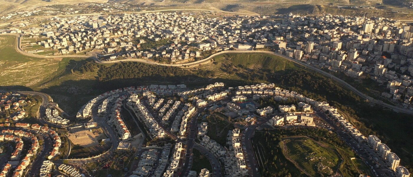 Why did Israeli settlers move into the Palestinian Territories?