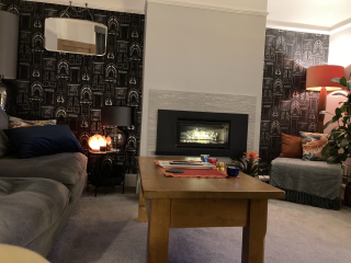 What can I do with grey sofa and carpet to make the room look warmer/cosier?
