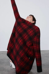 Standing pigeon-toed, looking at the ground while lightly touching your hair...