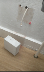 What is this white box which fell off wall, exposing a cable?