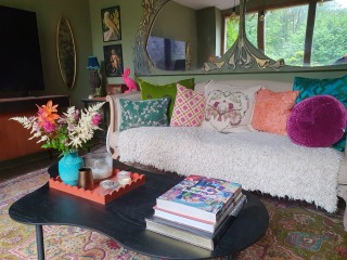 What can I do with grey sofa and carpet to make the room look warmer/cosier?