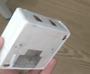 What is this white box which fell off wall, exposing a cable?