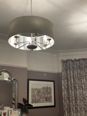 What can I do with grey sofa and carpet to make the room look warmer/cosier?