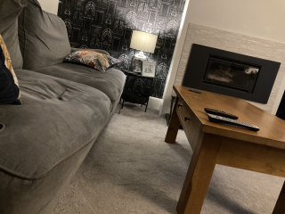 What can I do with grey sofa and carpet to make the room look warmer/cosier?