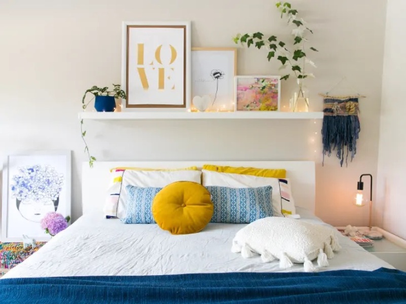 Three pictures over a bed