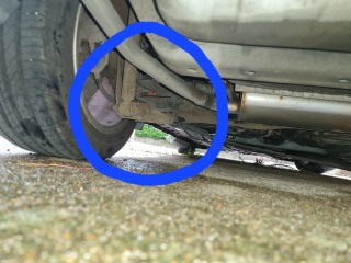 Anyone with basic car knowledge - car stands higher on one and some sort of spring is hanging lower on other side