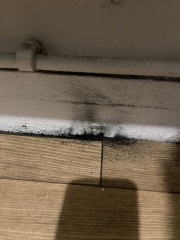 Black dust by skirting boards