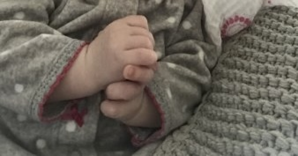 Own hand grasping/touching 11 month DD