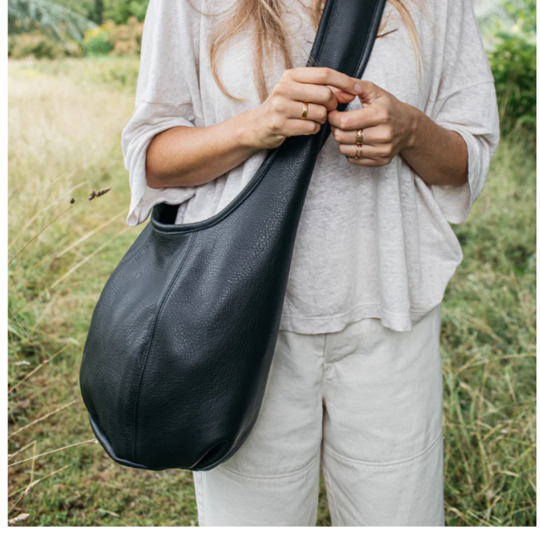 Large leather bag that says quality