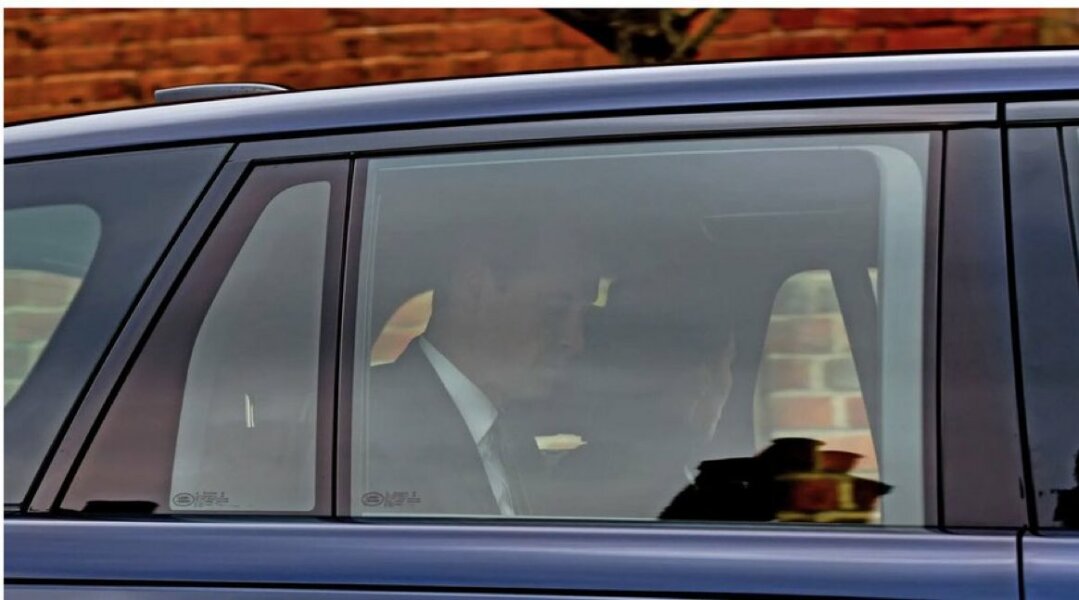 Kate in car with face turned away