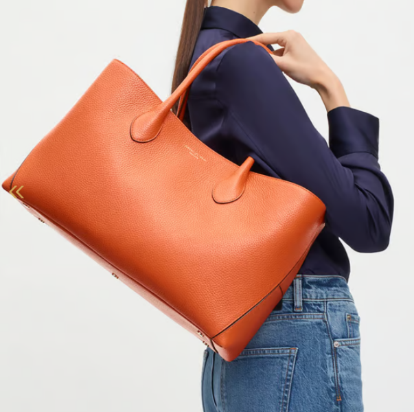 Large leather bag that says quality