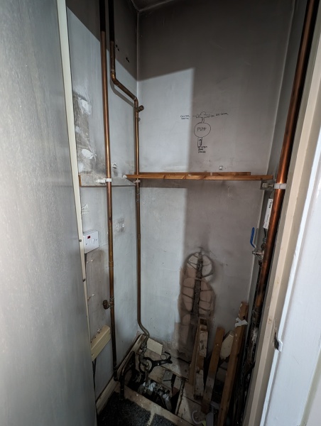 Hot water cylinder cupboard now empty, but new pipes in use