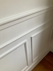 Wall panelling - continue in a small space in a corner or not?