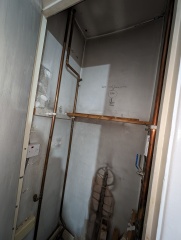 Hot water cylinder cupboard now empty, but new pipes in use