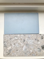 Which paint colour in a bathroom with blue-grey tiles?