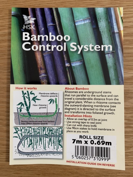 Raised flowerbed against wooden fence