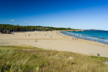 Where might we choose to holiday if we like sunny old towns, cafe culture, markets and white beaches.