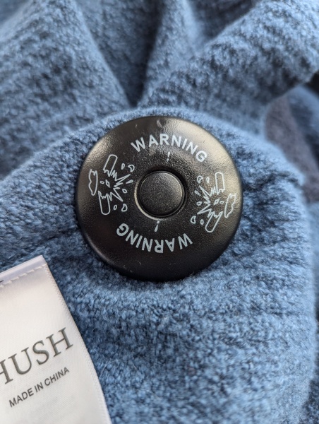 Removing a John Lewis security tag from a Hush garment