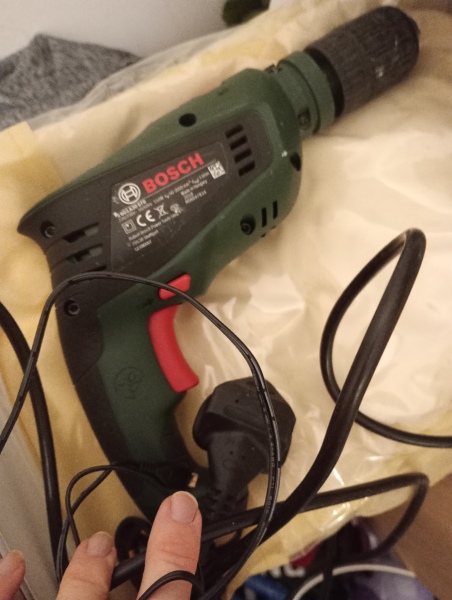 Drilling holes in an internal concrete wall for wall plugs and shelves