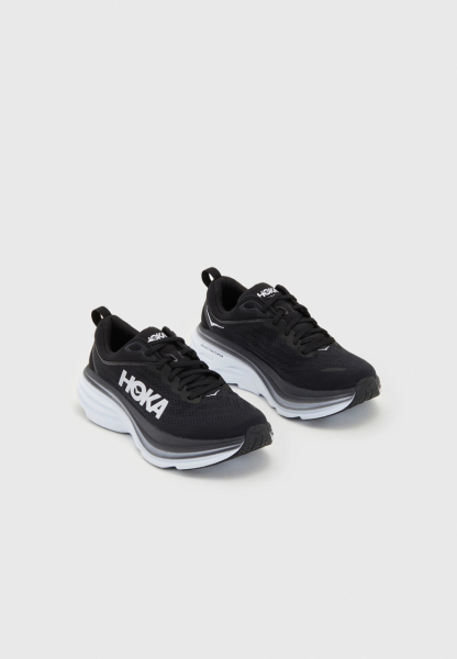Black trainers with thick white sole.