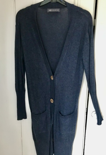 Cardigan nipped in at waist, flared over hips