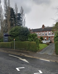 House on busy road beside offices?
