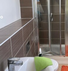 Fully tiled bathroom, what can I put over the tiles?