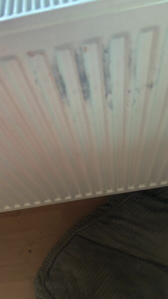 Help with black stains on white radiator please!