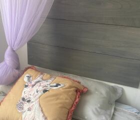 DS says his bed is like a prison bed - can I somehow attach a headboard ??