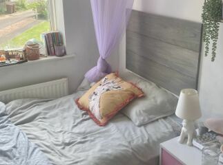 DS says his bed is like a prison bed - can I somehow attach a headboard ??
