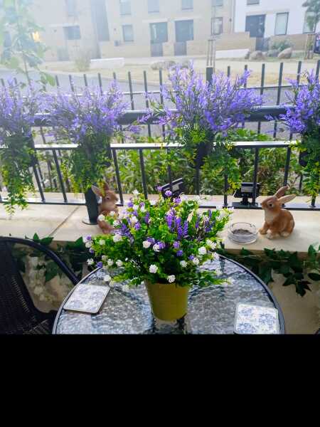 To find it strange to hang a fake flower wreath on your front door at the height of summer