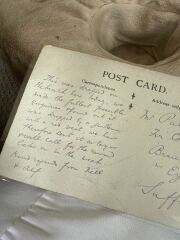Can you decipher two words on this antique postcard?