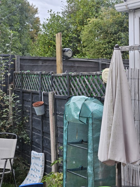 Neighbour attaching things to our fence?